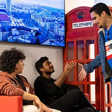 Students arriving and greeting eachother on campus