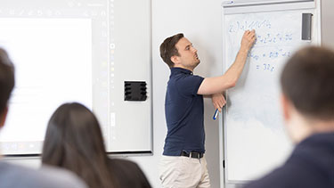 Lecturer working on whiteboard