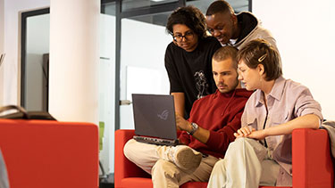 Group of students working on a laptop