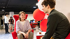 Student event with students talking and balloons in background