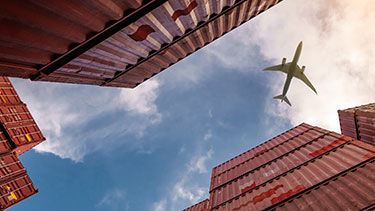 Container units with aeroplane flying overhead