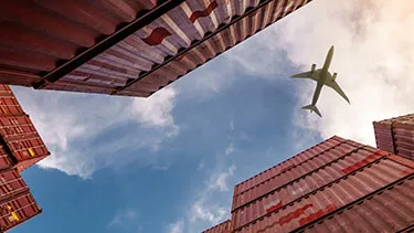 Container units with aeroplane flying overhead