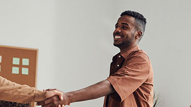 Male student shaking hands