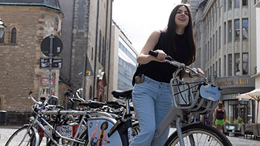 Female student on bike in Leipzig city