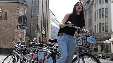Female student on bike in Leipzig city