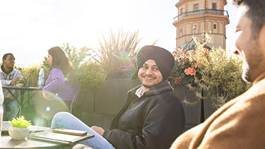 Students experiencing the social atmosphere of the campus roof terrace