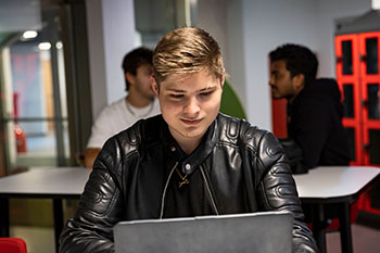 Male student working on a laptop