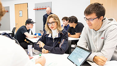 Students studying in lecture group work