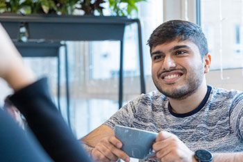 Male student taking to friend