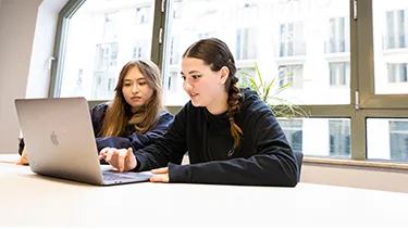 Female students working on laptop