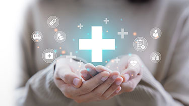 Hands holding icons related to medical health
