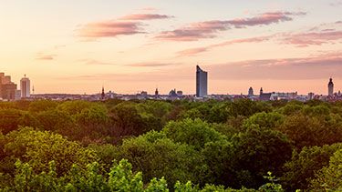 Leipzig city skyline with green trees in foreground