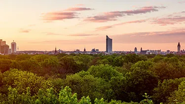 Leipzig city skyline with green trees in foreground
