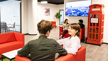 Students sitting and socialising in campus reception area