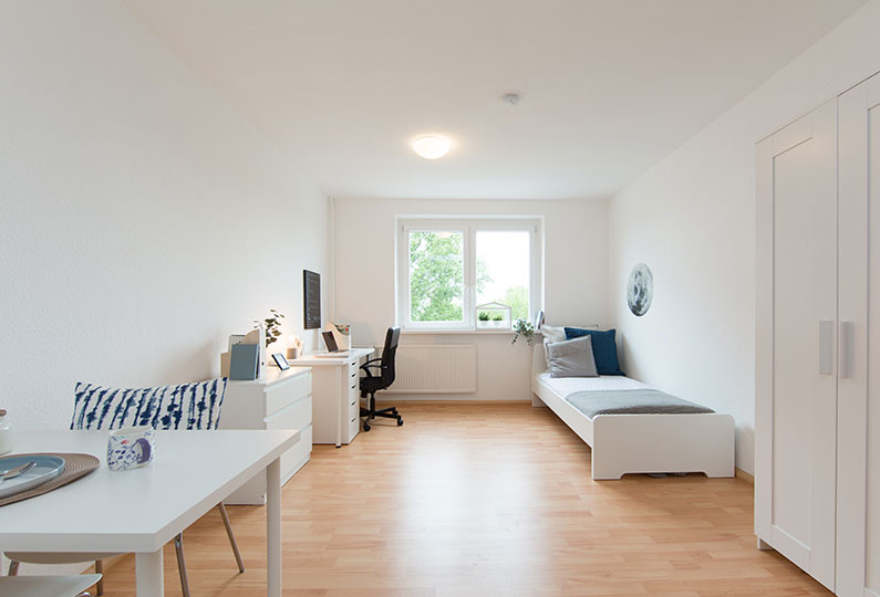 Bedroom with study table and cupboard