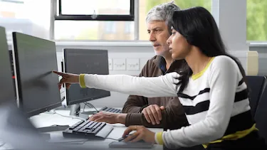 Student and faculty discussion in the computer study room