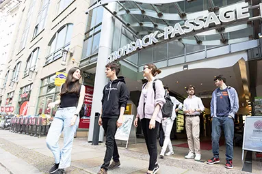 Group of students walking in front of shopping mall