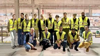 Group of students wearing high-visibility vests and standing together